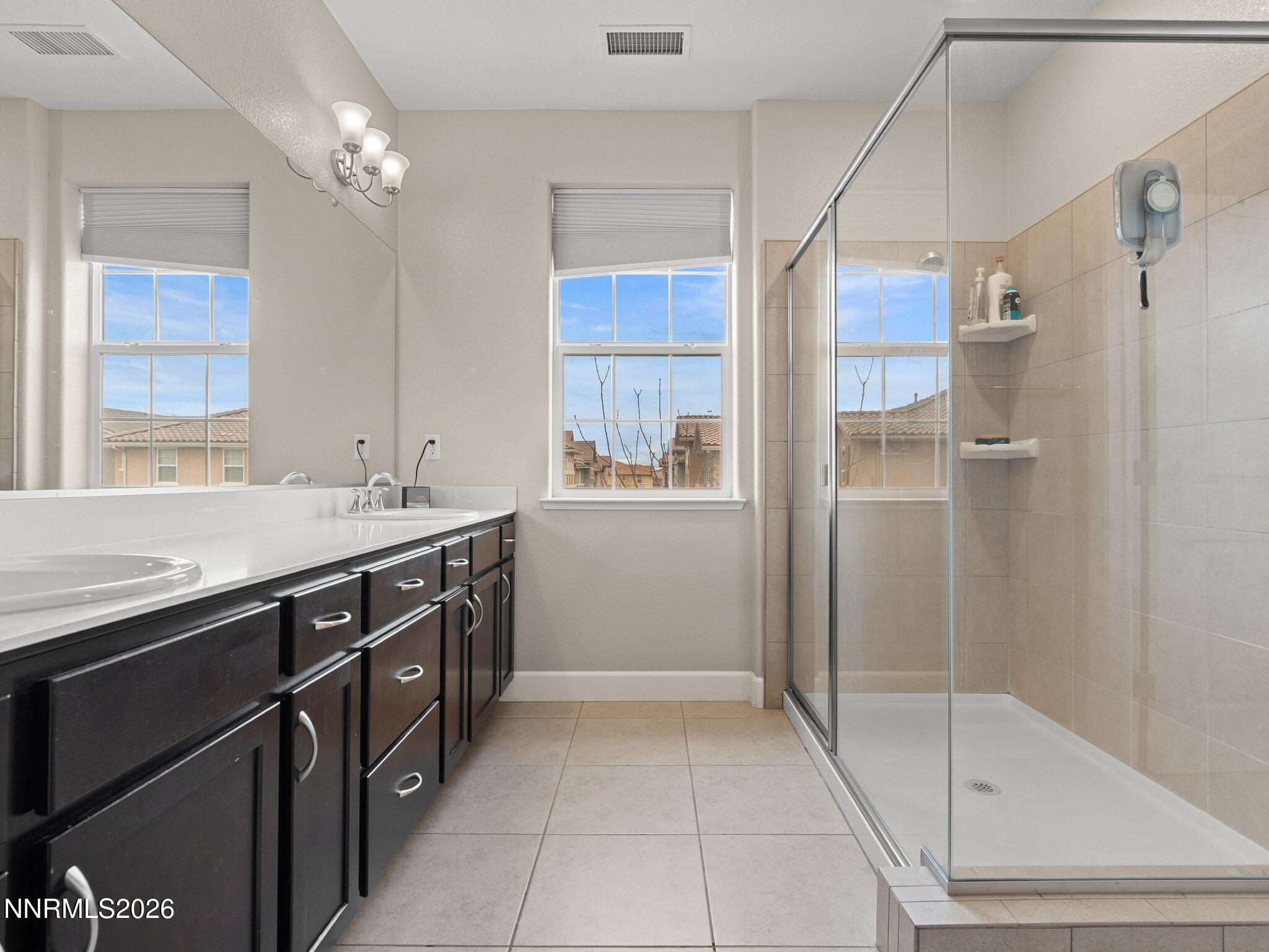 1914 Sea Horse Road, Unit C Reno, NV 89521 - Photo 19 of 28 a spacious bathroom with a shower sink and mirror