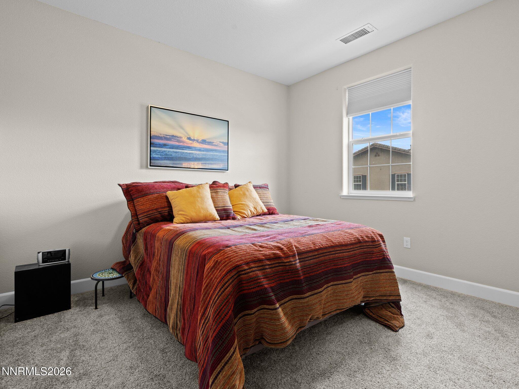1914 Sea Horse Road, Unit C Reno, NV 89521 - Photo 21 of 28 a bed sitting in a bedroom next to a window