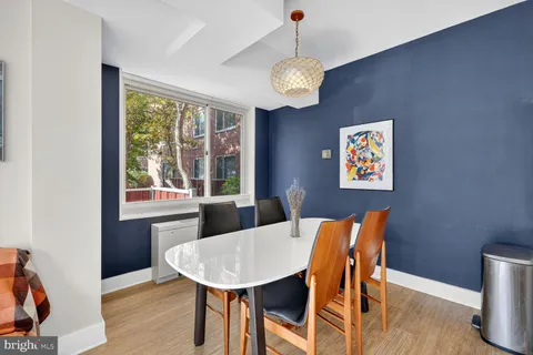 a view of a dining room with furniture a chandelier and wooden floor