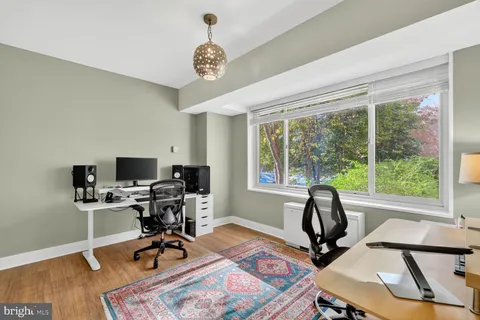 a view of a workspace with furniture and a window