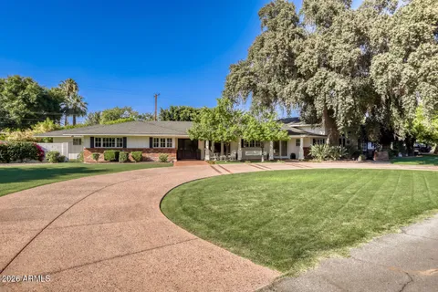 an aerial view of a house with a yard basket ball court and outdoor seating