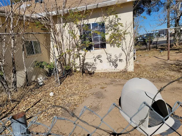 a backyard of a house with large trees