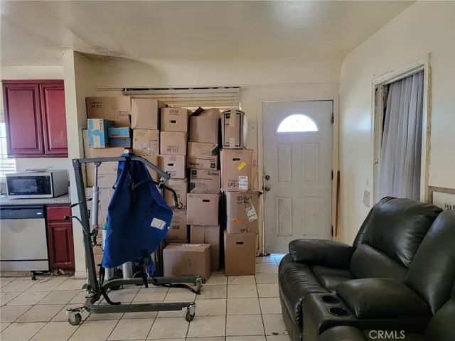 a living room with furniture a desk and chair