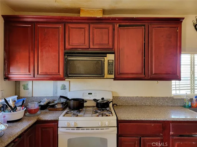 a kitchen with a stove and a microwave