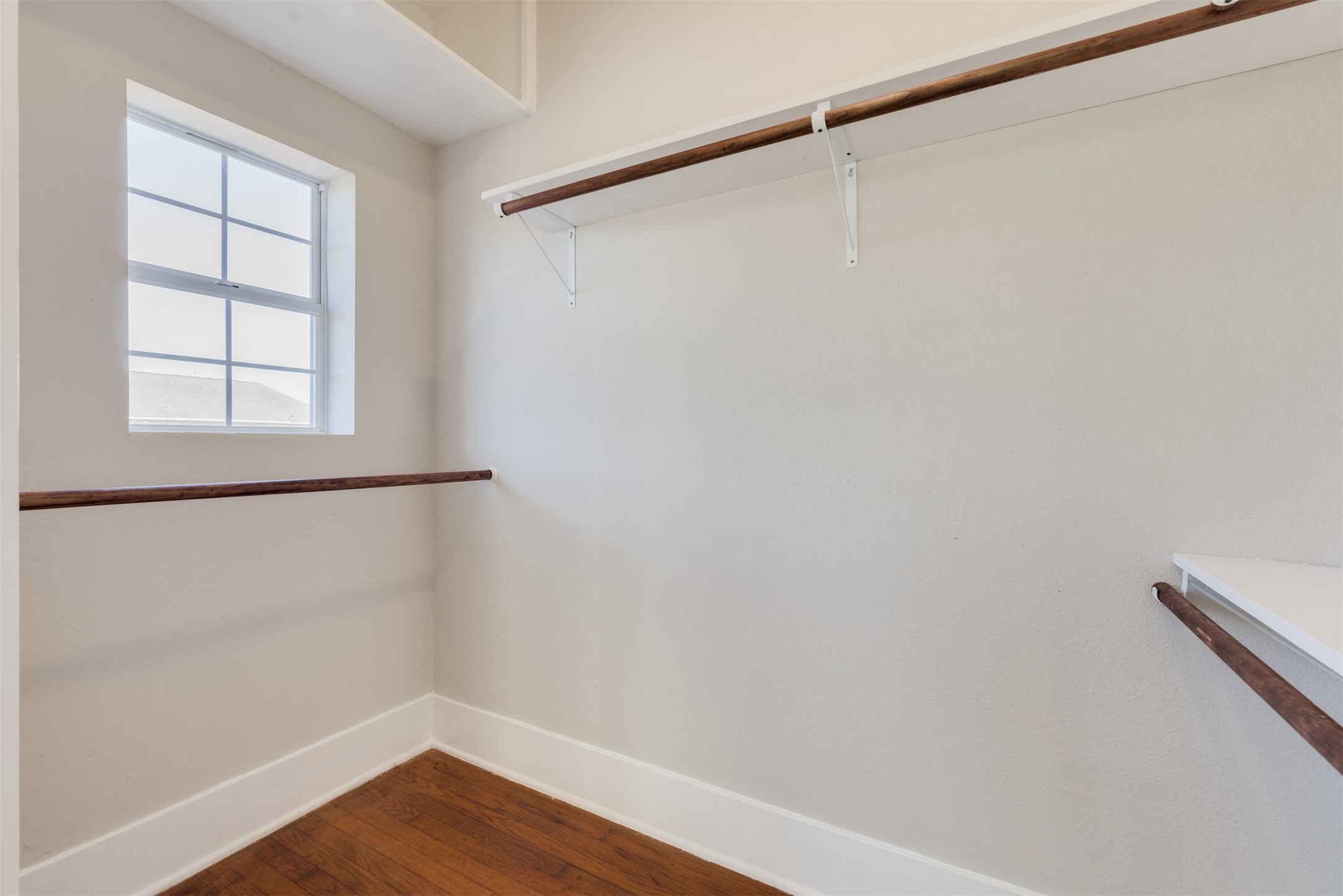 1219 West Gray Street, Unit 2 Houston, TX 77019 - Photo 10 of 25 a view of a small space with wooden floor and a window
