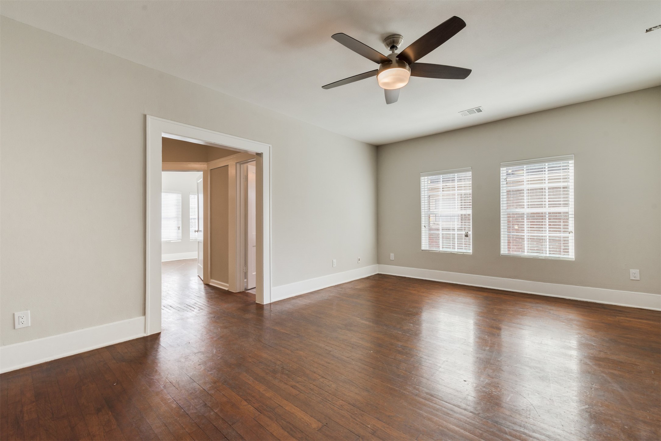 1219 West Gray Street, Unit 2 Houston, TX 77019 - Photo 12 of 25 wooden floor in an empty room with a window