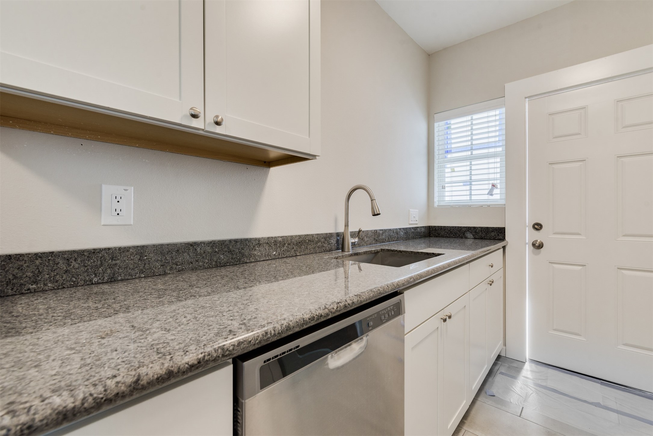 1219 West Gray Street, Unit 2 Houston, TX 77019 - Photo 17 of 25 a kitchen with granite countertop a sink and cabinets