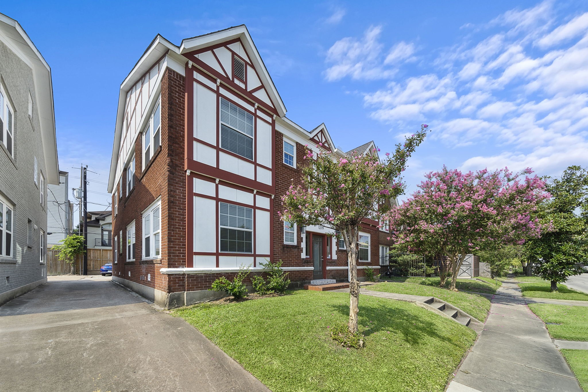 1219 West Gray Street, Unit 2 Houston, TX 77019 - Photo 2 of 25 a view of a brick building next to a yard