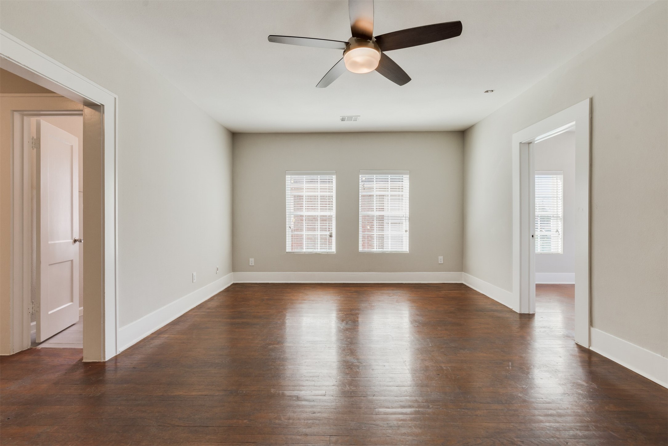 1219 West Gray Street, Unit 2 Houston, TX 77019 - Photo 6 of 25 a view of empty room with wooden floor and fan
