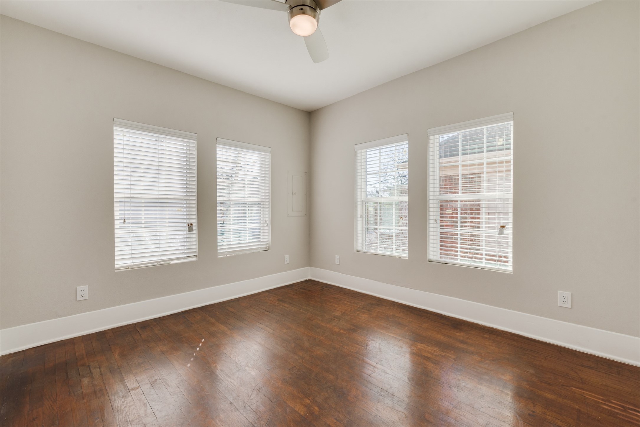 1219 West Gray Street, Unit 2 Houston, TX 77019 - Photo 9 of 25 a view of an empty room with wooden floor and a window