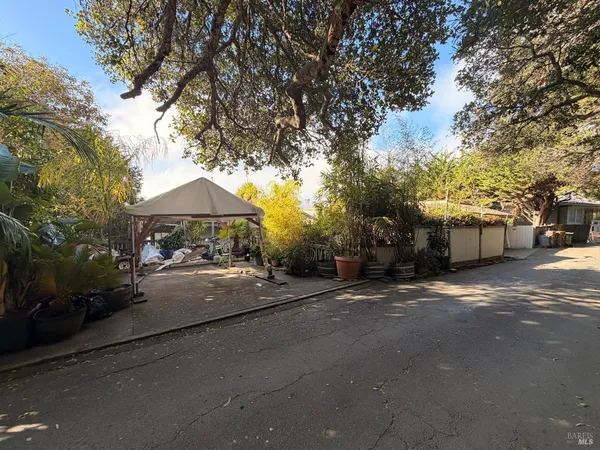 a couple of table and chairs under an umbrella