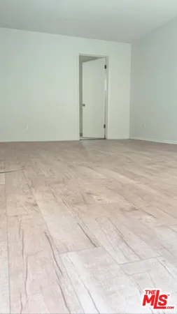 a view of a kitchen with a dishwasher and white cabinets