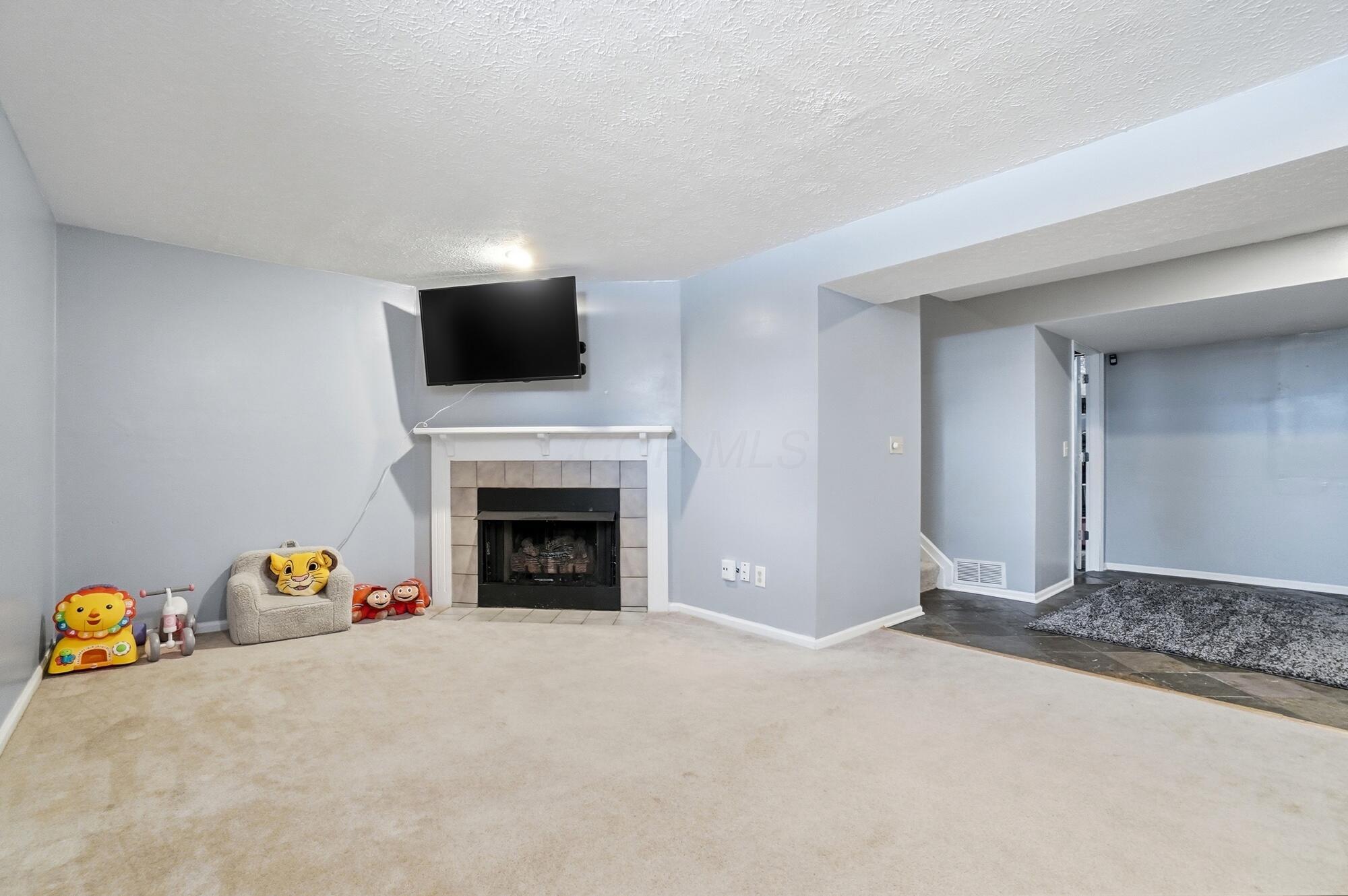 6938 Avery Road Dublin, OH 43017 - Photo 29 of 40 Finished Basement with a GAS log fireplace