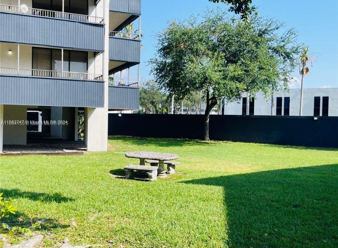 16220 Northwest 2nd Avenue, Unit 213 Miami, FL 33169 - Photo 1 of 22 a front view of a house with a yard