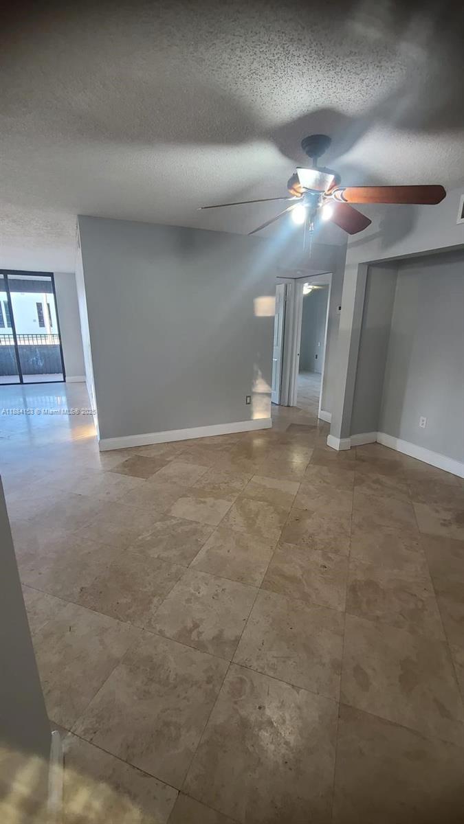 16220 Northwest 2nd Avenue, Unit 213 Miami, FL 33169 - Photo 11 of 22 a view of a livingroom and a ceiling fan