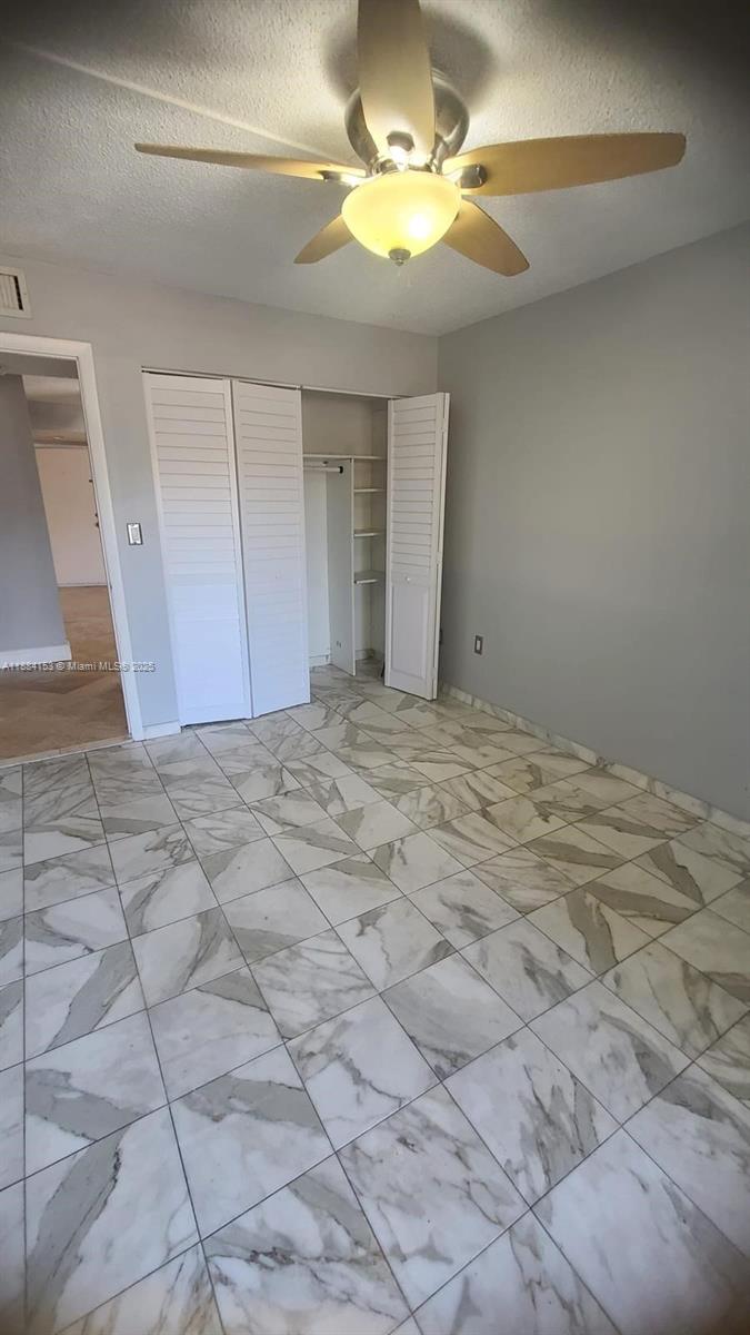 16220 Northwest 2nd Avenue, Unit 213 Miami, FL 33169 - Photo 19 of 22 a view of an empty room and chandelier fan