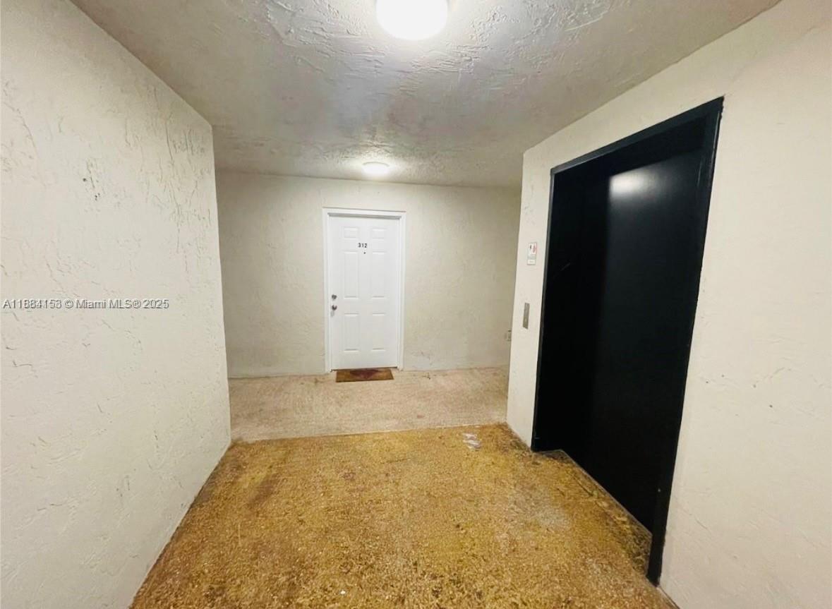 16220 Northwest 2nd Avenue, Unit 213 Miami, FL 33169 - Photo 2 of 22 an empty room with closet