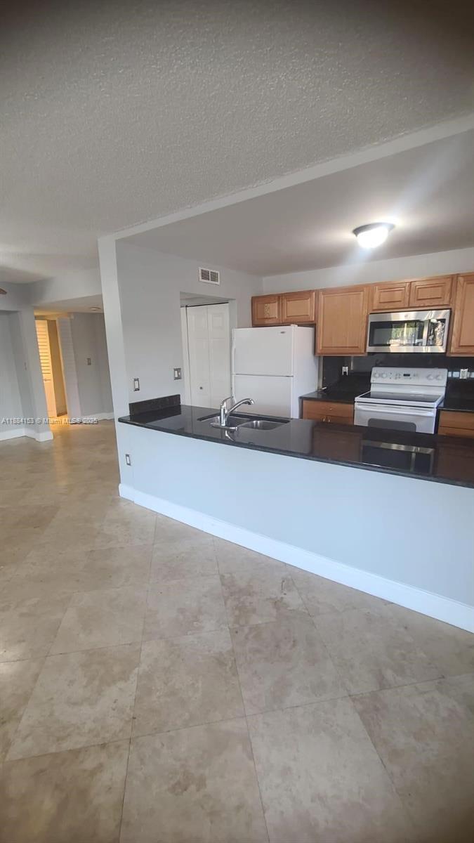 16220 Northwest 2nd Avenue, Unit 213 Miami, FL 33169 - Photo 4 of 22 a view of a kitchen with a sink