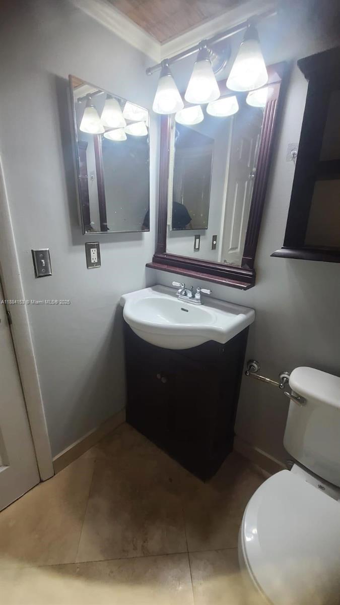 16220 Northwest 2nd Avenue, Unit 213 Miami, FL 33169 - Photo 8 of 22 a bathroom with a toilet sink and mirror