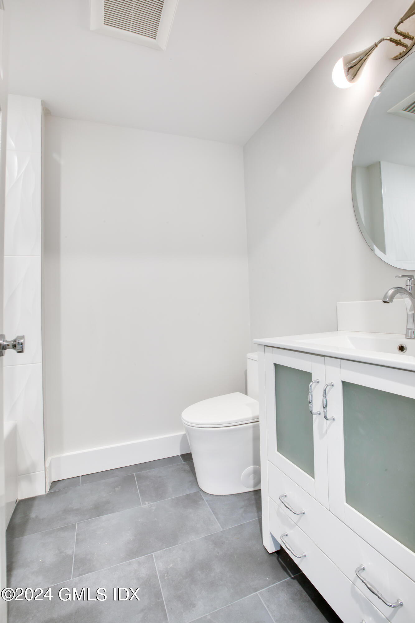 40 Prospect Street, Unit 1 Greenwich, CT 06830 - Photo 12 of 18 a bathroom with a sink toilet and mirror