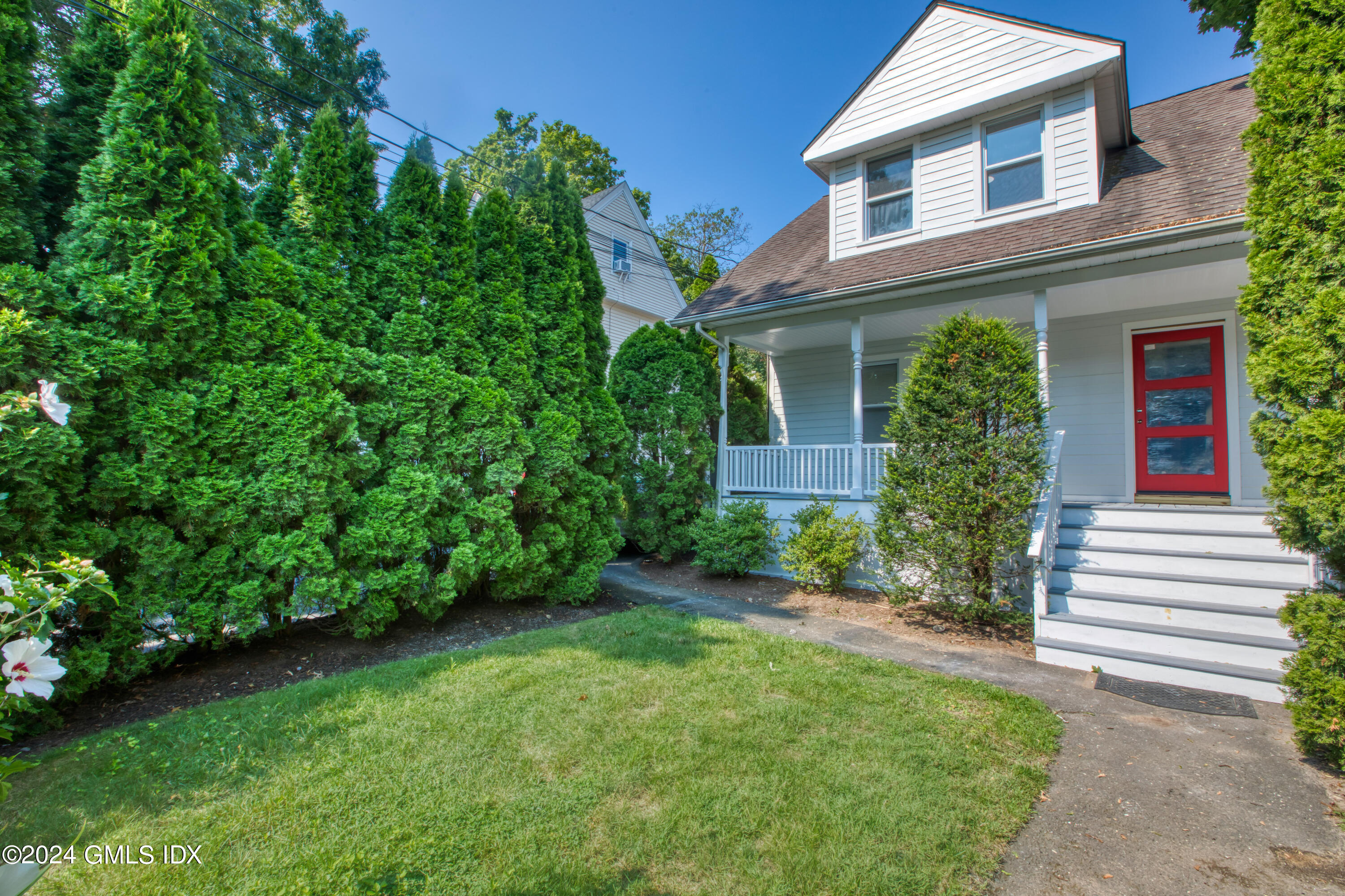 40 Prospect Street, Unit 1 Greenwich, CT 06830 - Photo 16 of 18 front view of a house with a yard