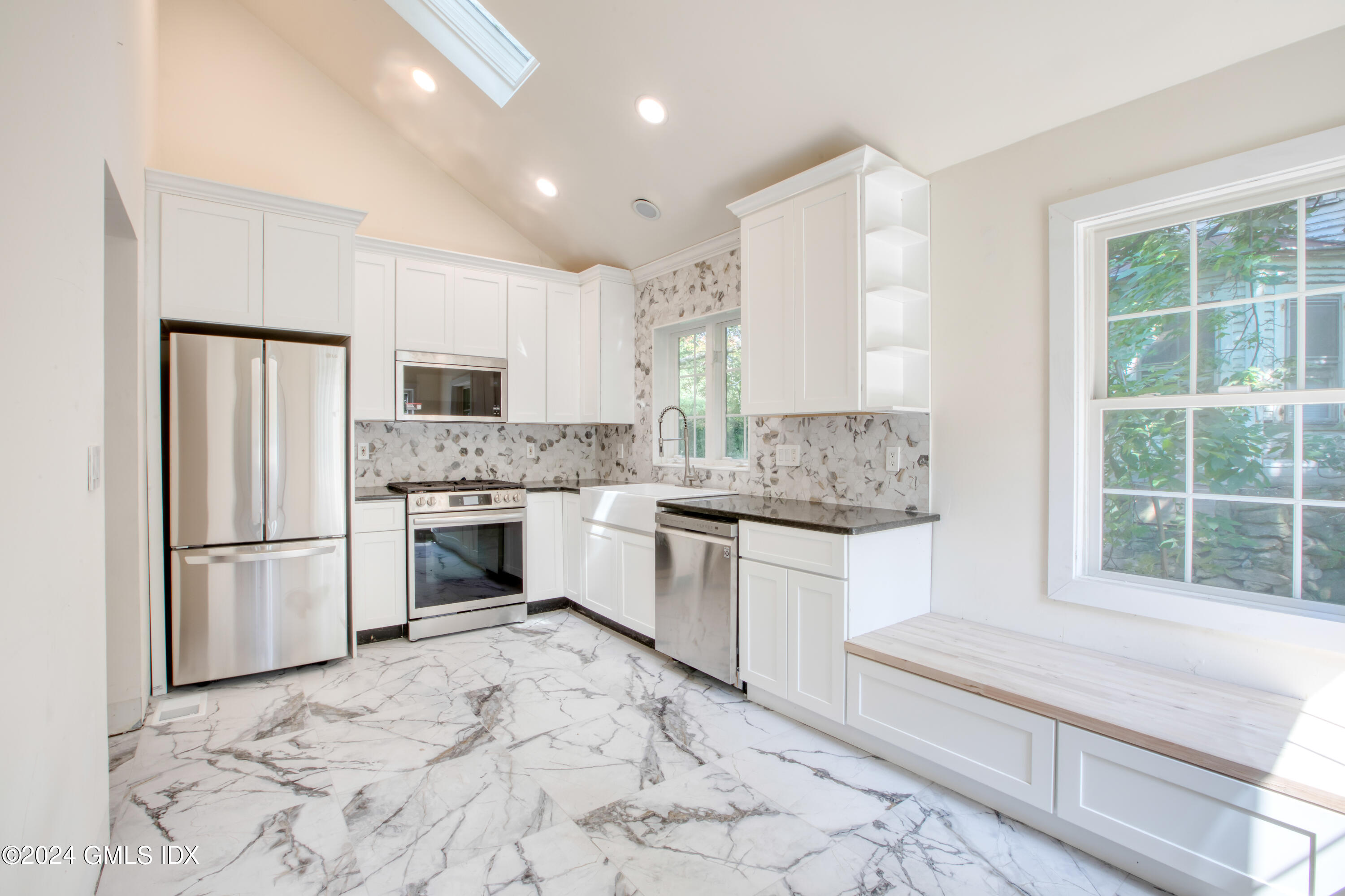 40 Prospect Street, Unit 1 Greenwich, CT 06830 - Photo 2 of 18 a kitchen with white cabinets and white appliances