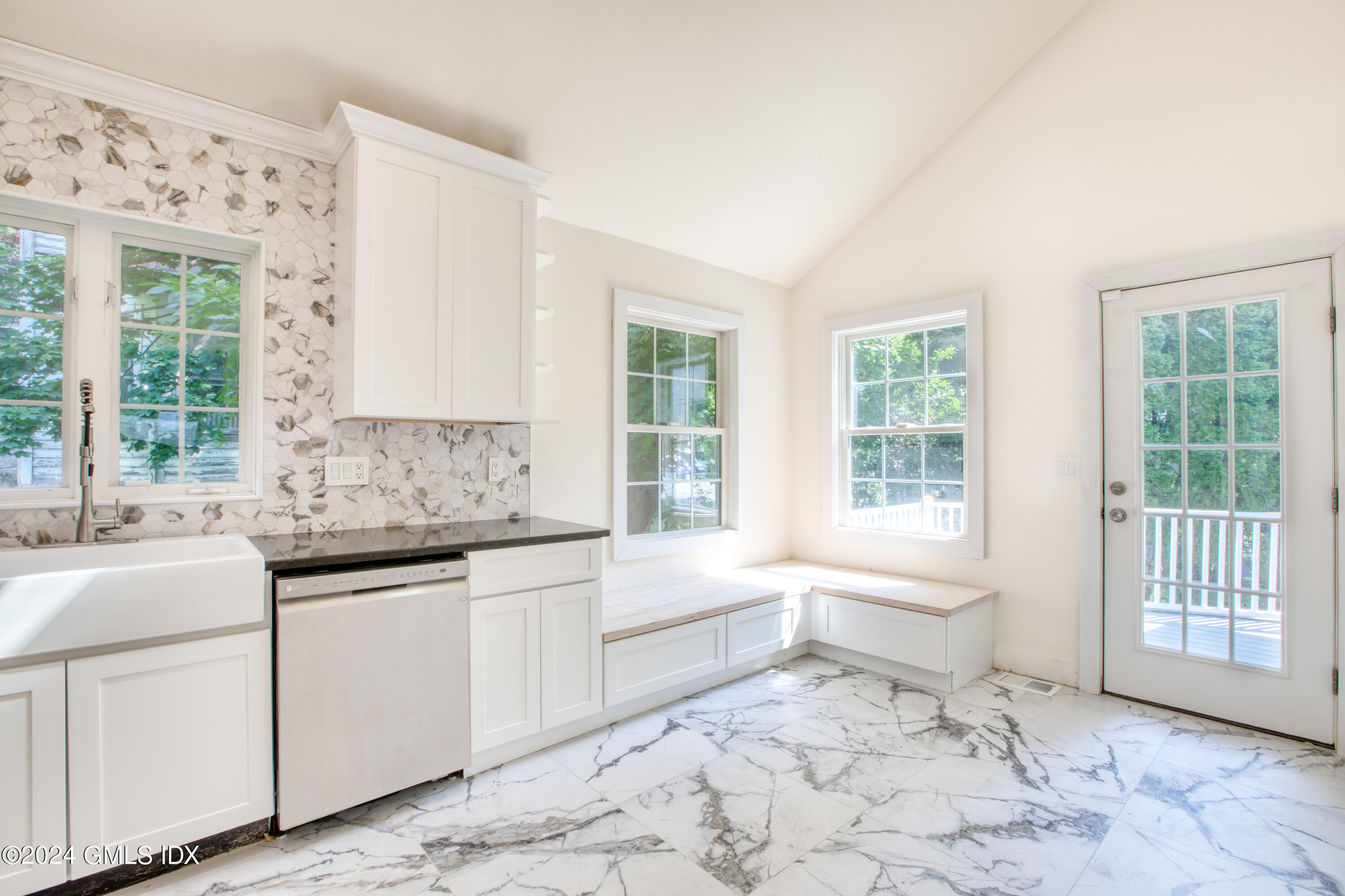 40 Prospect Street, Unit 1 Greenwich, CT 06830 - Photo 4 of 18 a kitchen with granite countertop a sink and white cabinets