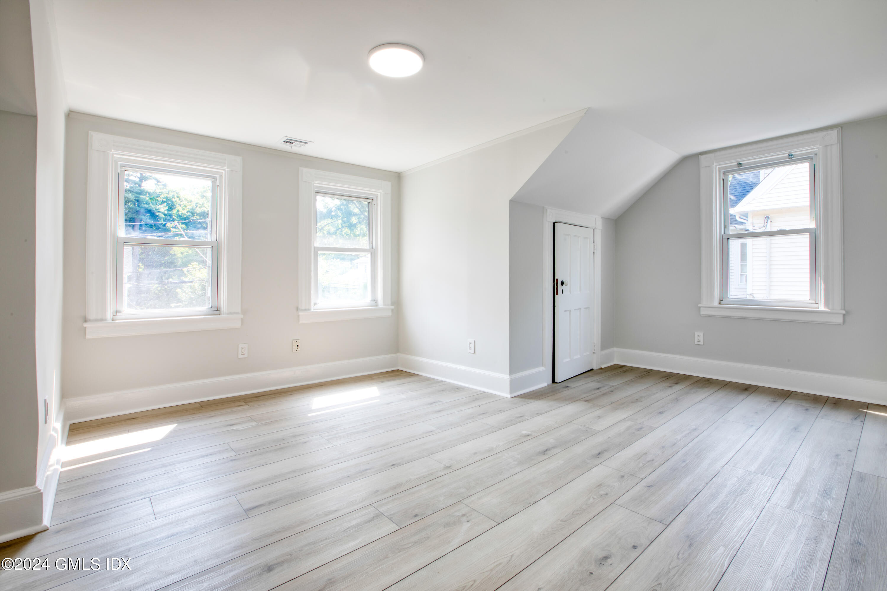 40 Prospect Street, Unit 1 Greenwich, CT 06830 - Photo 5 of 18 an empty room with wooden floor and windows