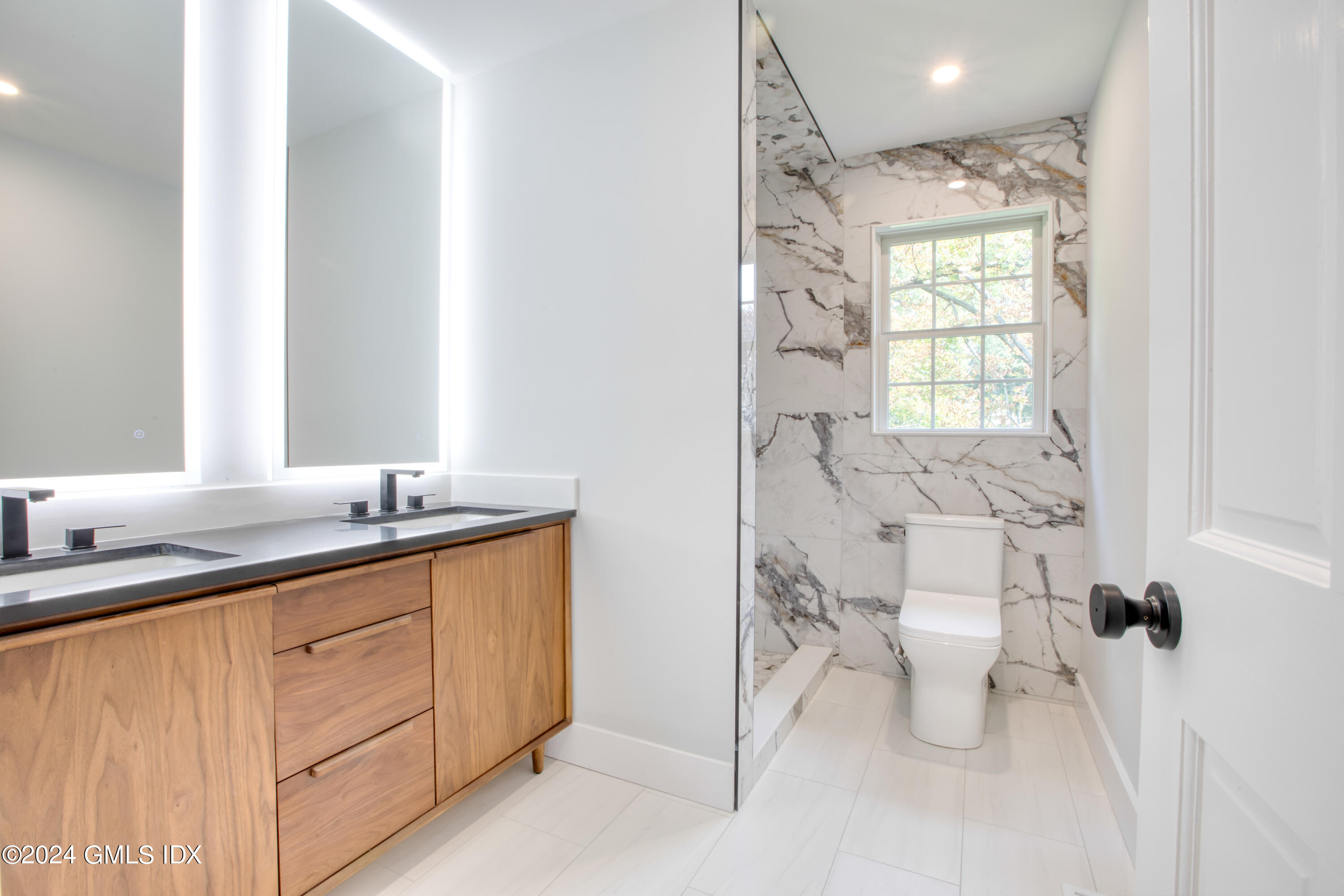 40 Prospect Street, Unit 1 Greenwich, CT 06830 - Photo 6 of 18 a bathroom with a granite countertop sink toilet and shower