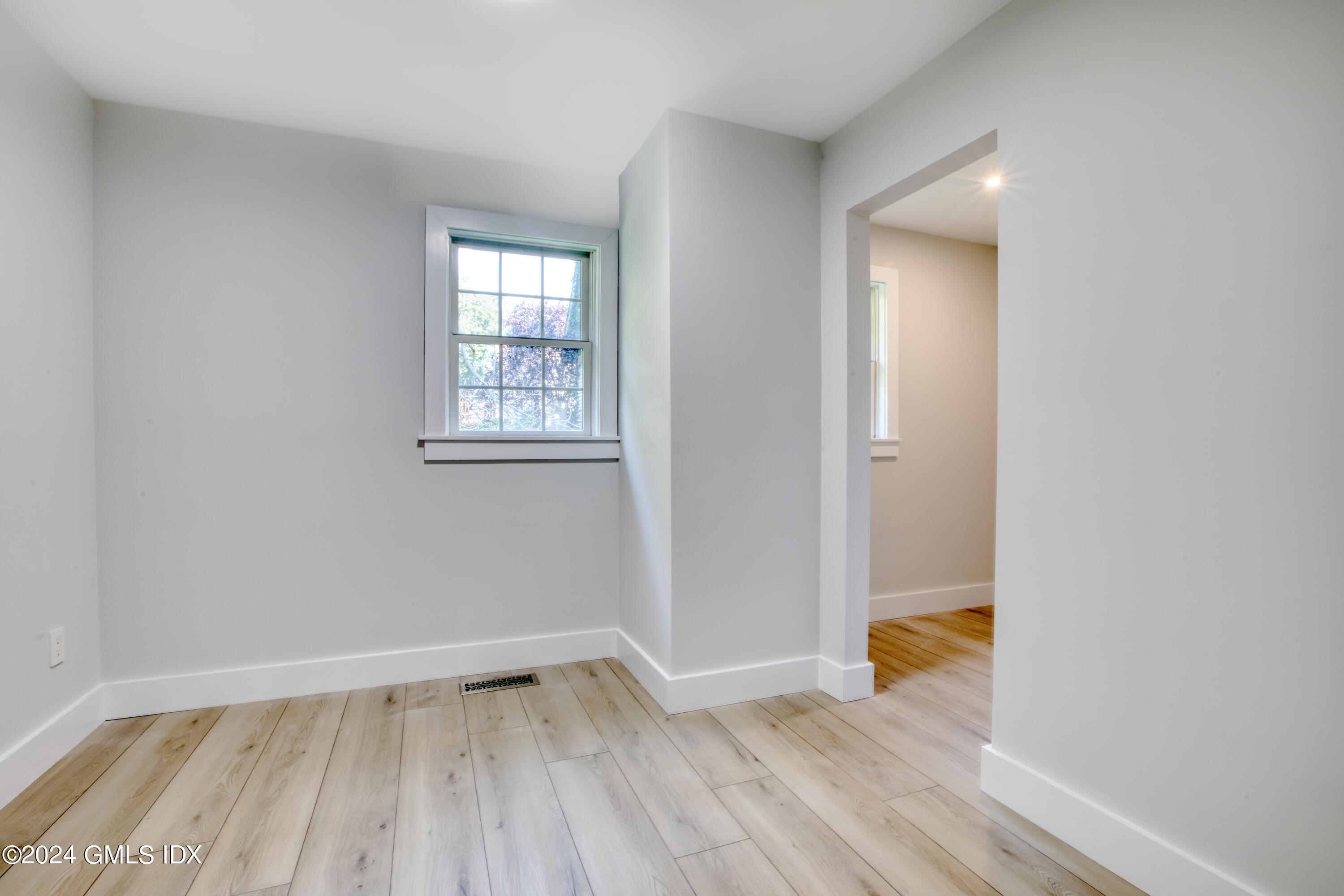40 Prospect Street, Unit 1 Greenwich, CT 06830 - Photo 9 of 18 an empty room with wooden floor and windows