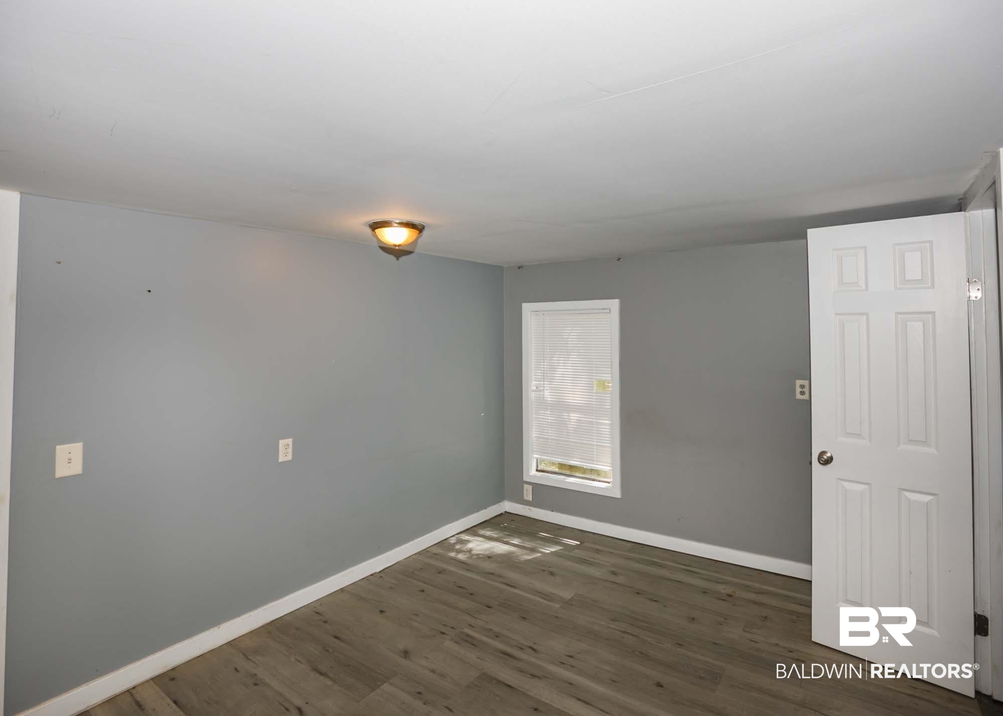 11998 Workman Avenue Foley, AL 36535 - Photo 44 of 59 Empty room with wood finished floors and baseboards