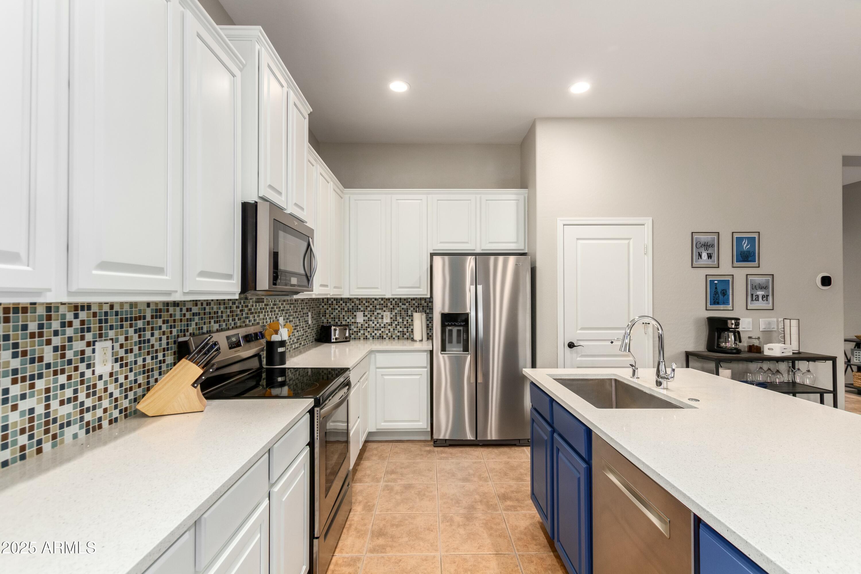3419 West Zuni Brave Trail Phoenix, AZ 85086 - Photo 15 of 51 a kitchen with a sink a stove and refrigerator