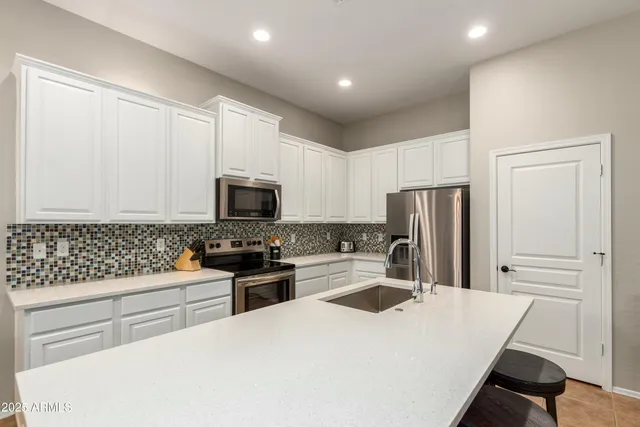 a kitchen with granite countertop a sink and a stove