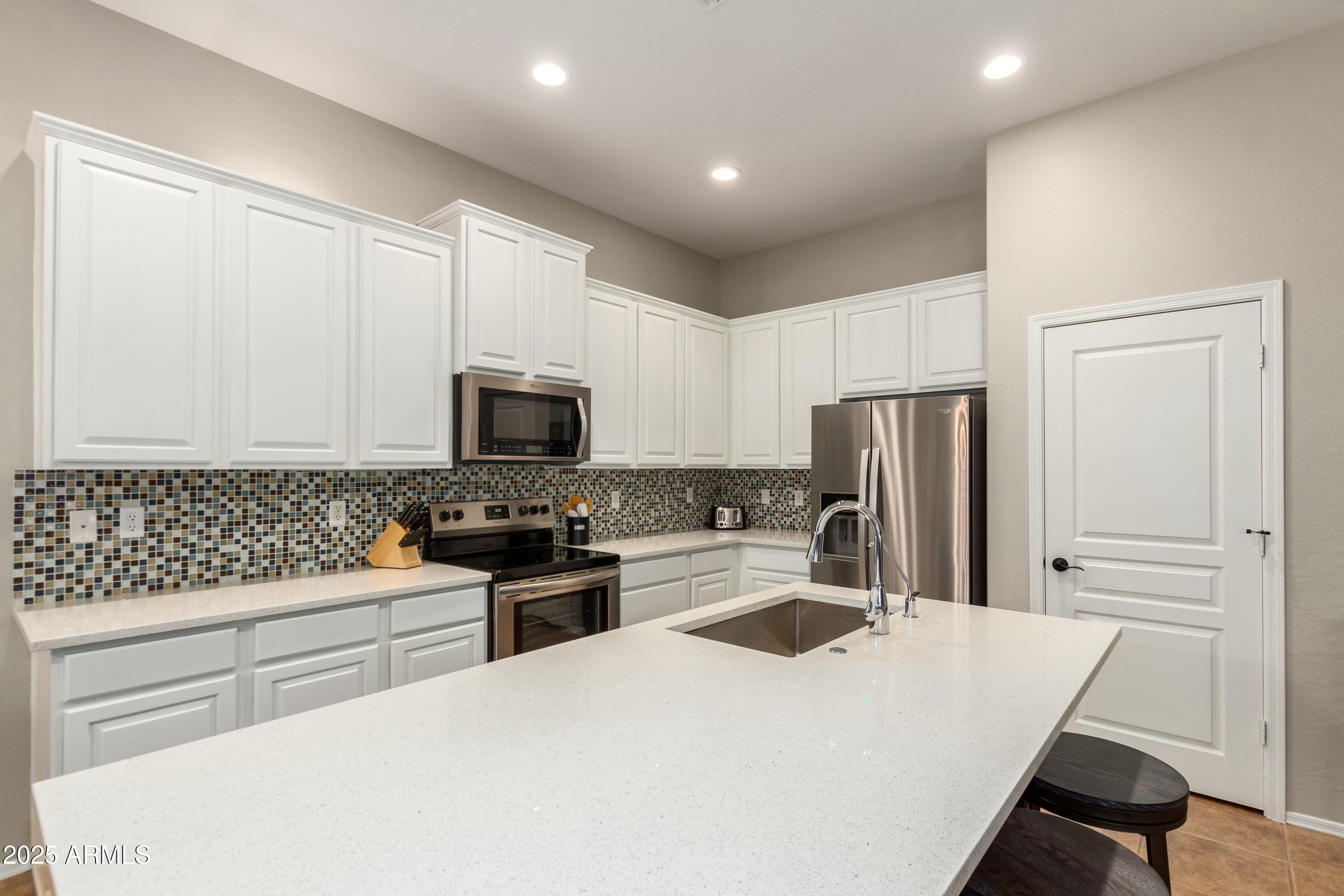 3419 West Zuni Brave Trail Phoenix, AZ 85086 - Photo 16 of 51 a kitchen with a sink a stove and refrigerator