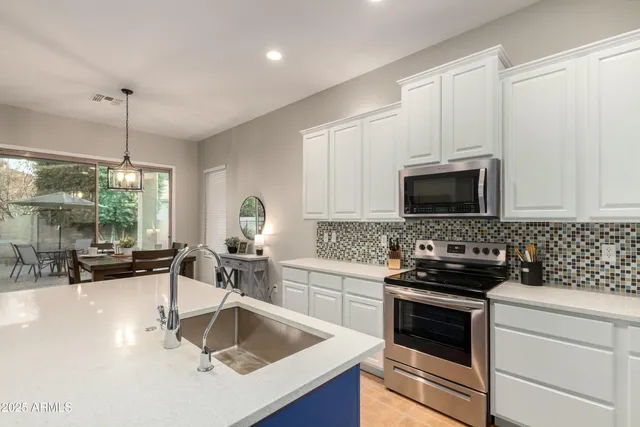 a bedroom with a bed a window and a flat screen television