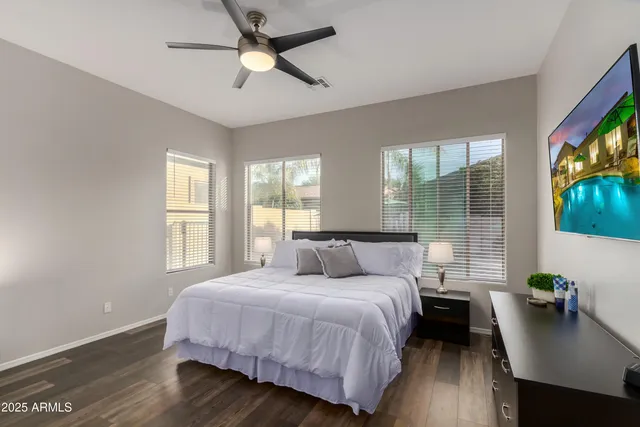 a bedroom with a bed and a tv