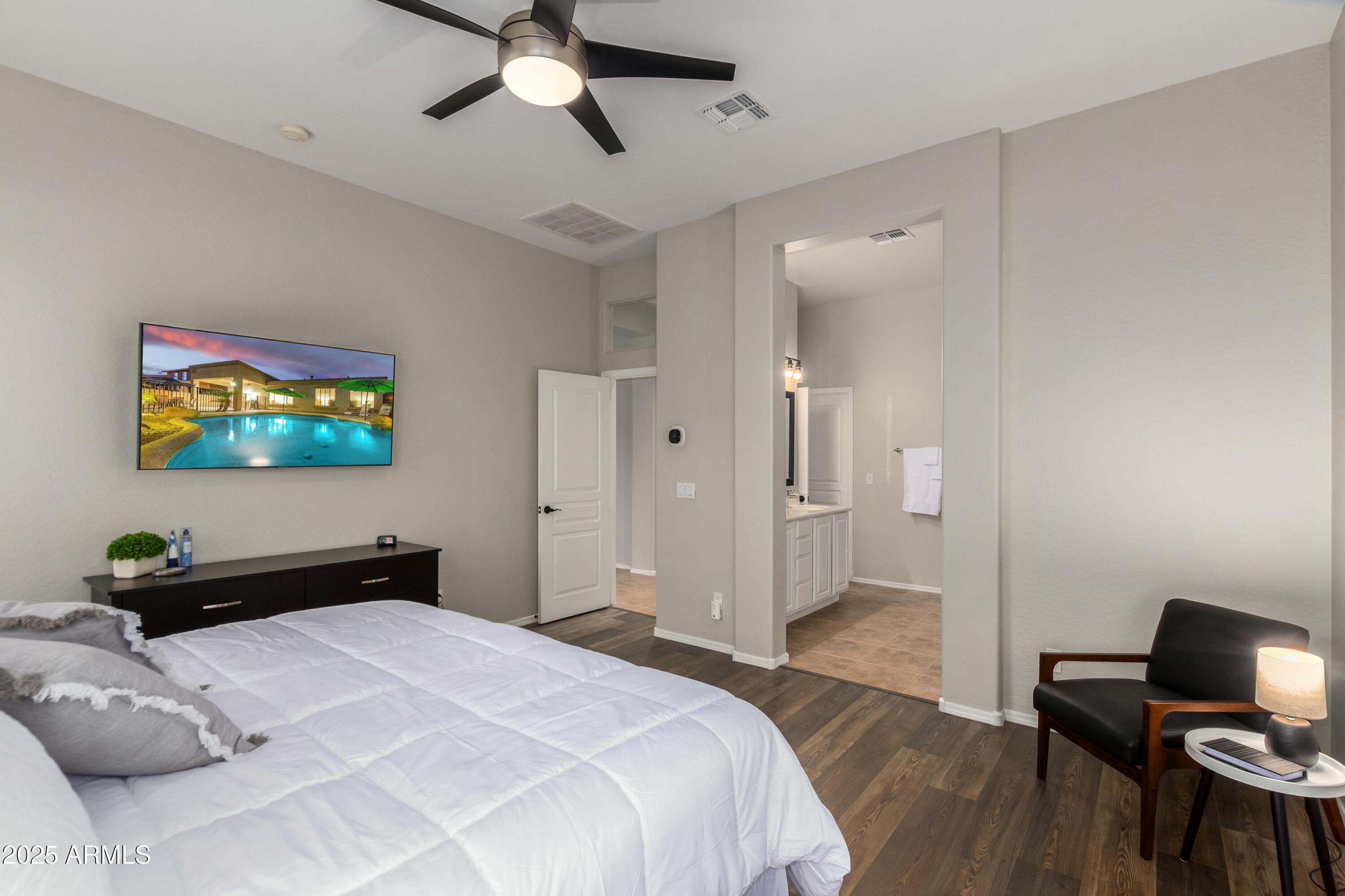 3419 West Zuni Brave Trail Phoenix, AZ 85086 - Photo 19 of 51 a bedroom with a bed and a tv