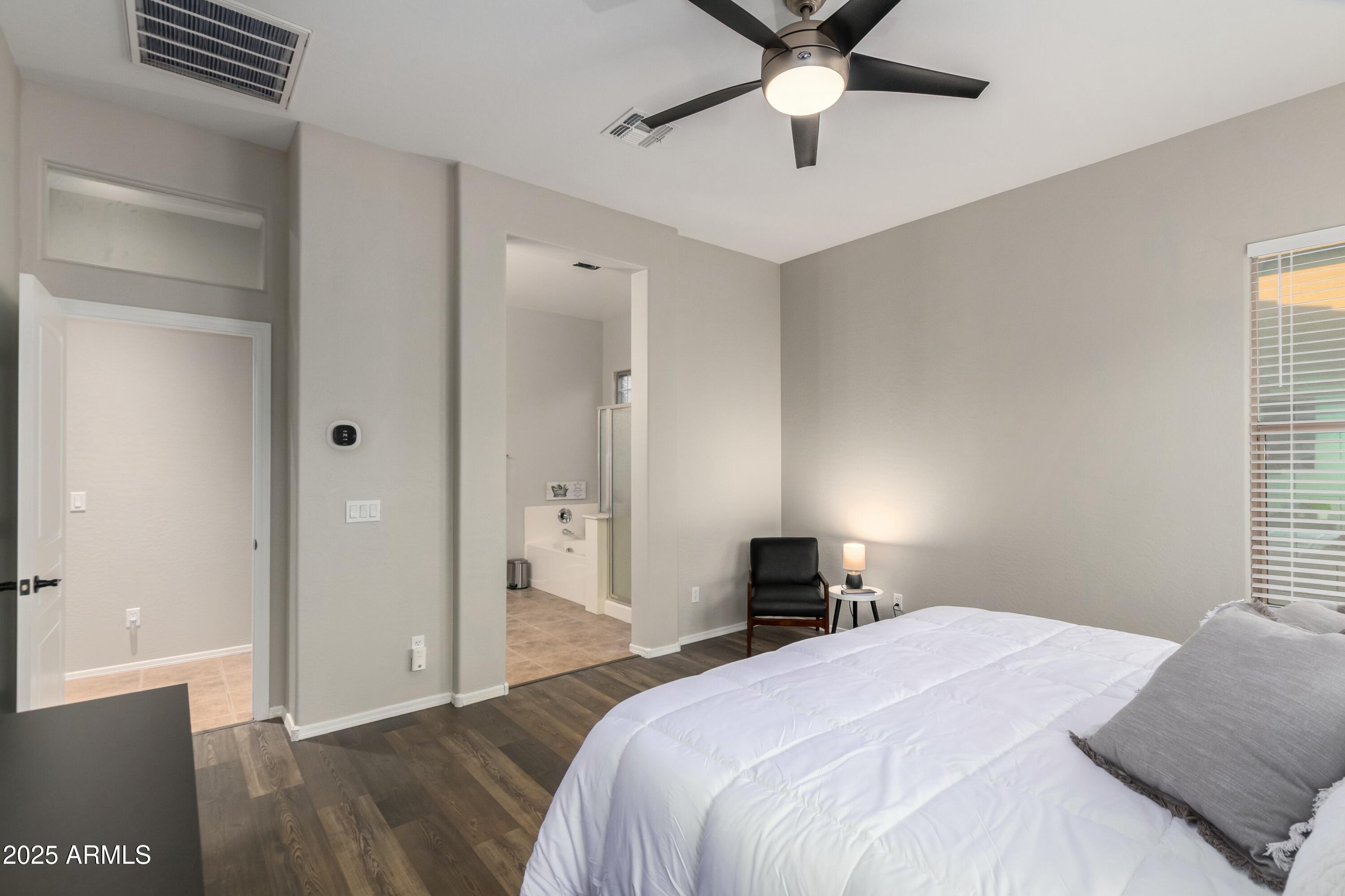 3419 West Zuni Brave Trail Phoenix, AZ 85086 - Photo 20 of 51 a bedroom with a bed and a chandelier