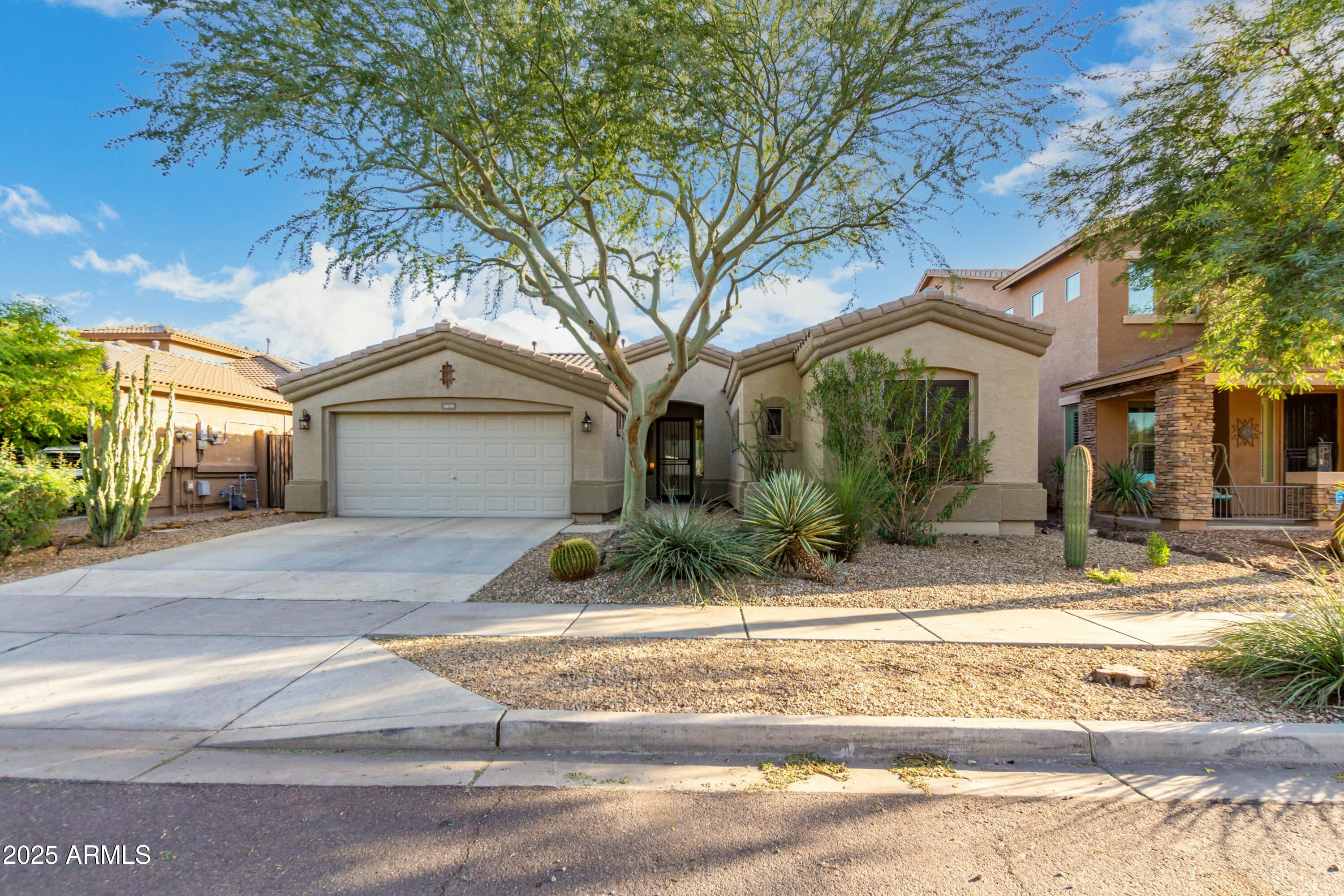 3419 West Zuni Brave Trail Phoenix, AZ 85086 - Photo 2 of 51 a view of a house with street that has a tree