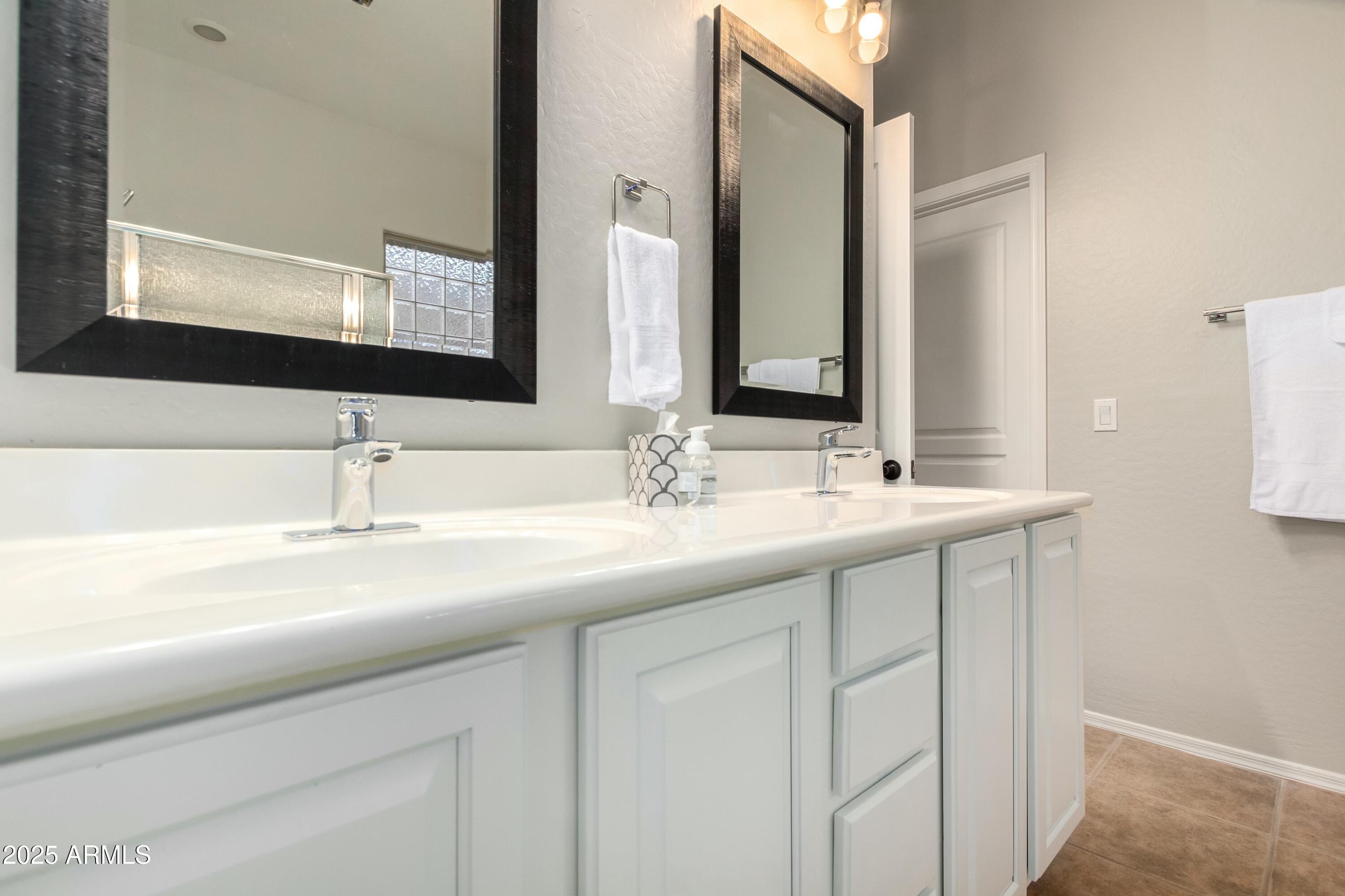 3419 West Zuni Brave Trail Phoenix, AZ 85086 - Photo 21 of 51 a bathroom with double sink and a mirror