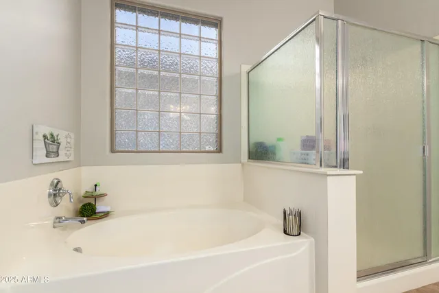 a bedroom with a bed and a potted plant