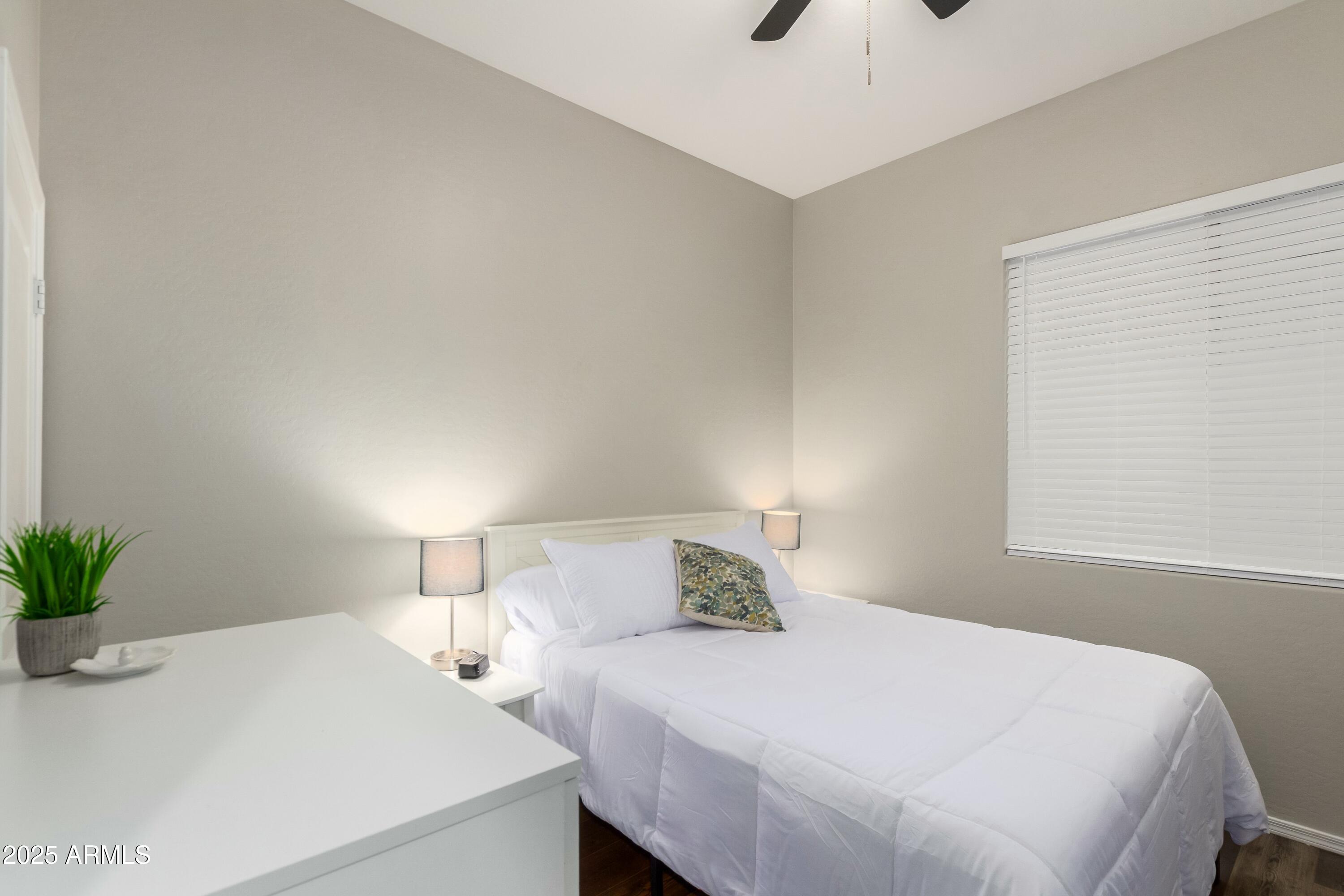 3419 West Zuni Brave Trail Phoenix, AZ 85086 - Photo 24 of 51 a bedroom with a bed and a potted plant