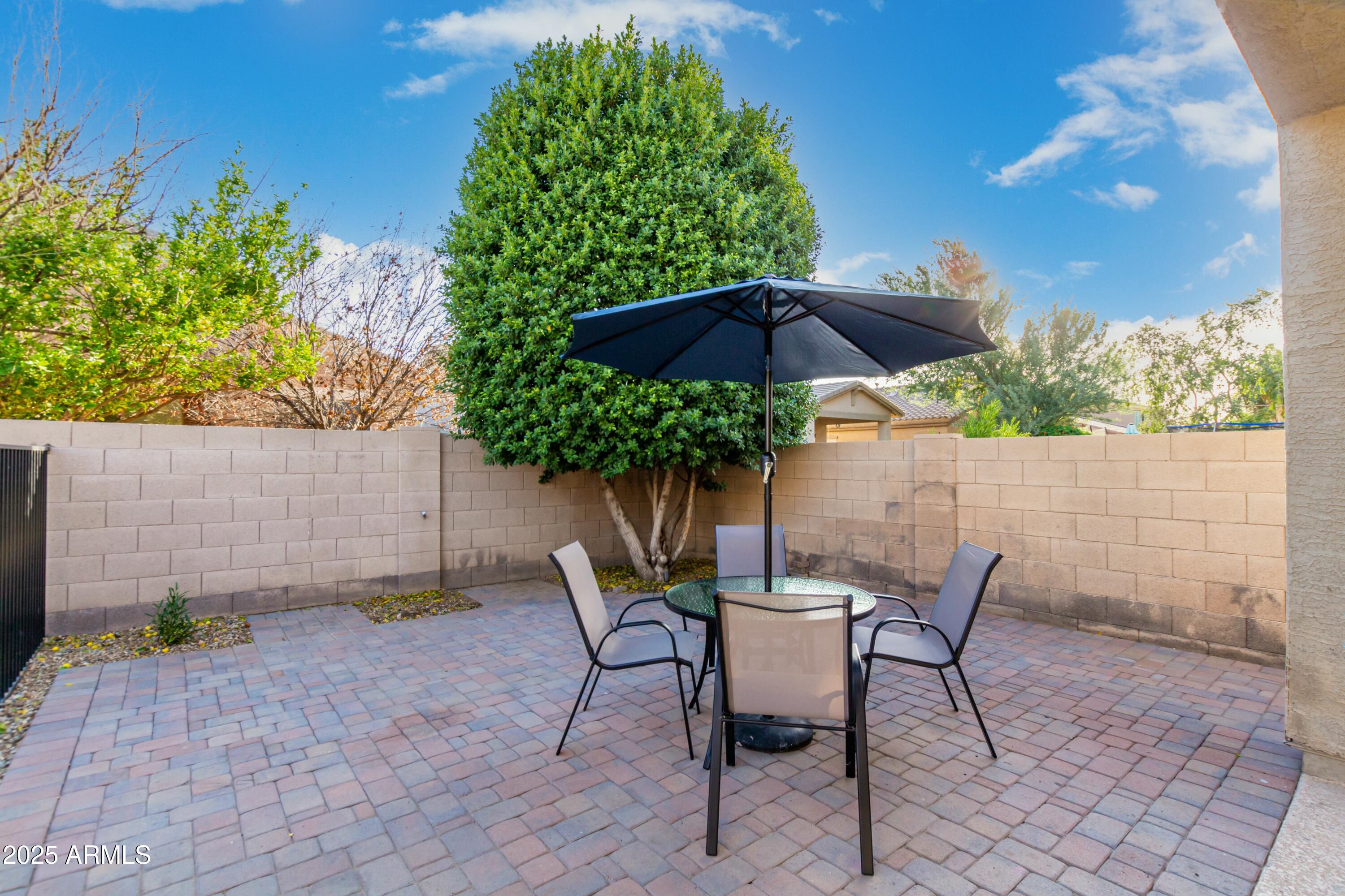 3419 West Zuni Brave Trail Phoenix, AZ 85086 - Photo 31 of 51 a patio with a patio table and chairs