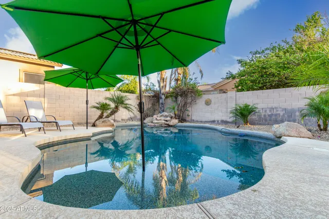 a patio table and chairs under an umbrella