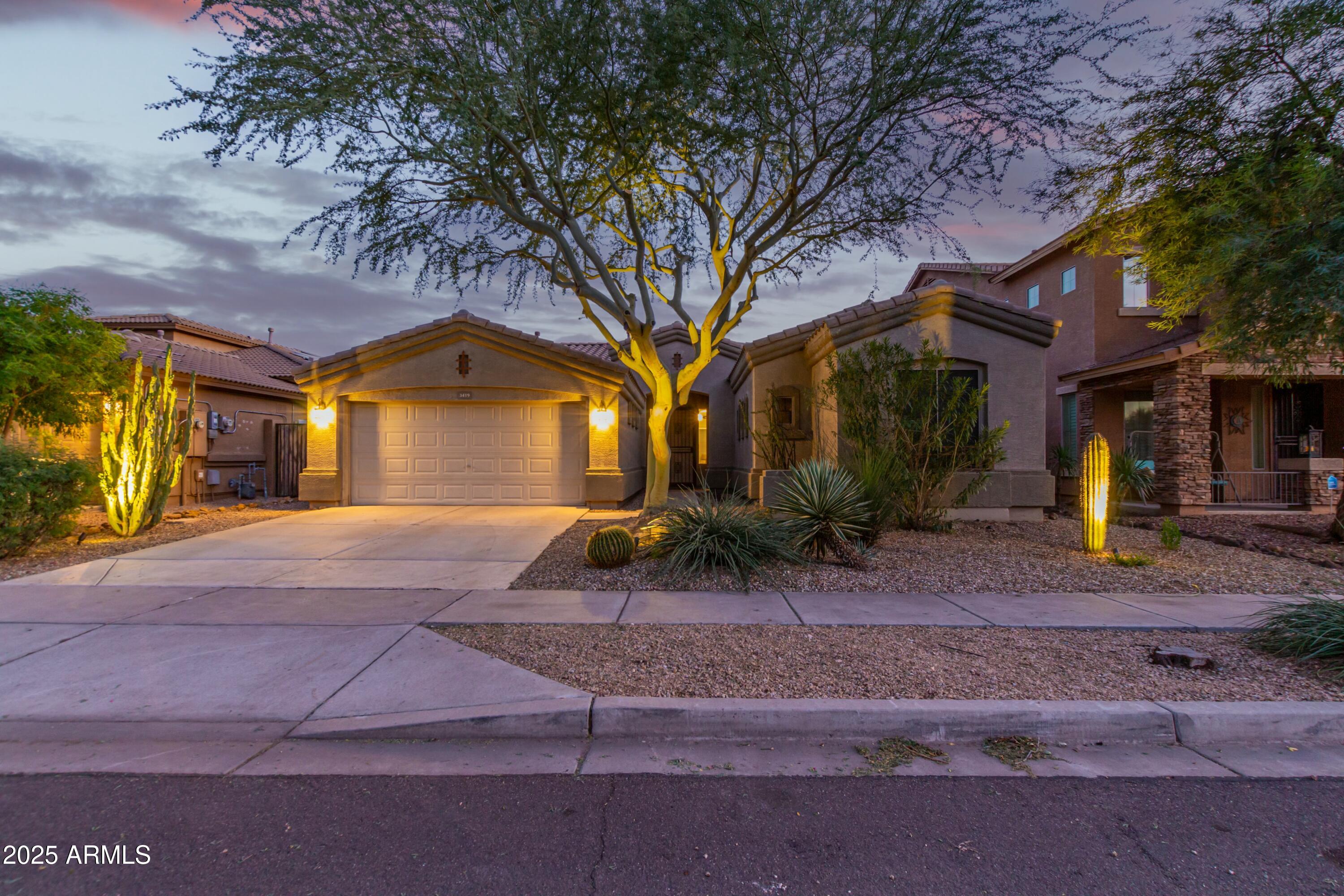 3419 West Zuni Brave Trail Phoenix, AZ 85086 - Photo 41 of 51 a front view of a house with garden