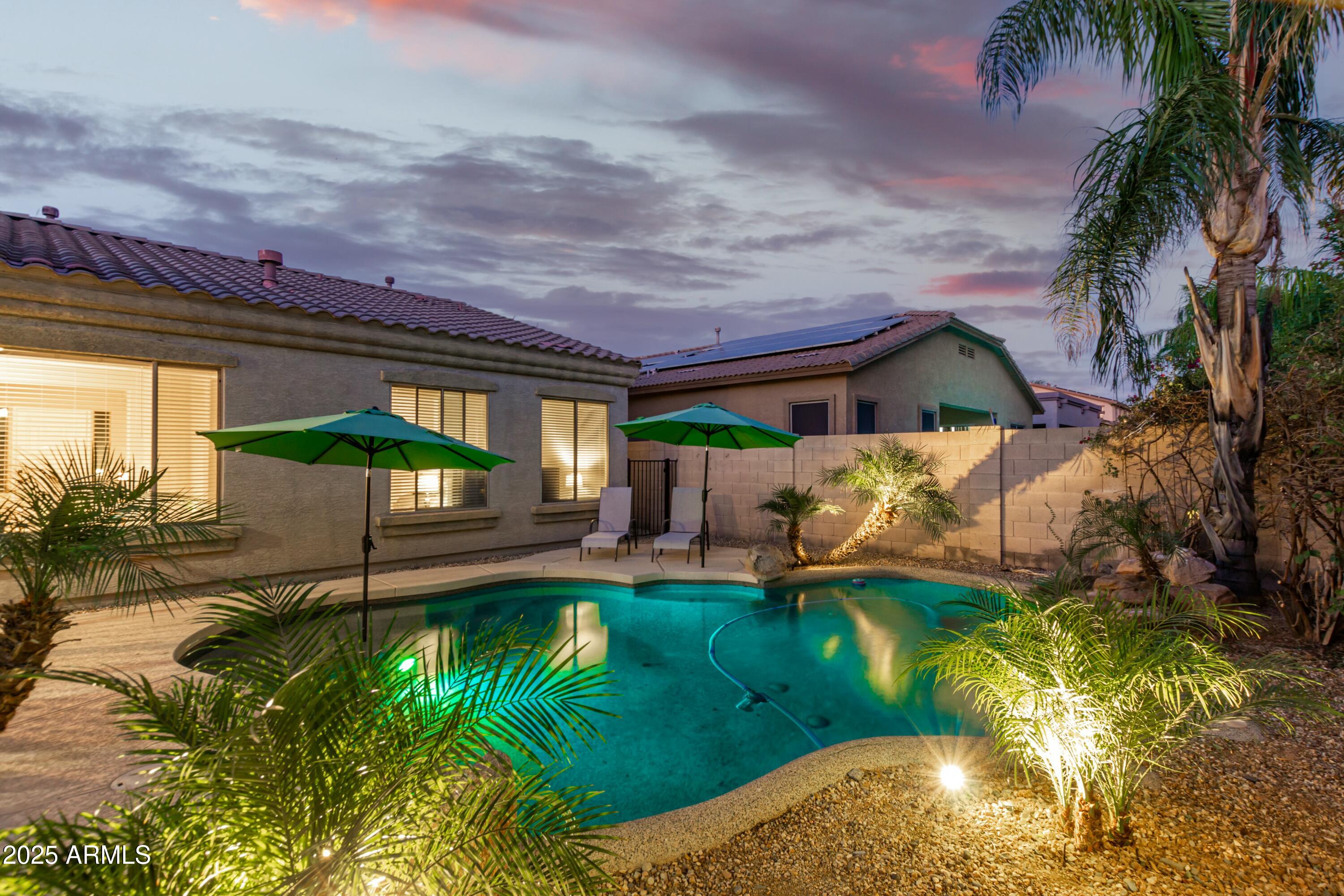 3419 West Zuni Brave Trail Phoenix, AZ 85086 - Photo 43 of 51 a view of a patio with table and chairs potted plants and palm tree
