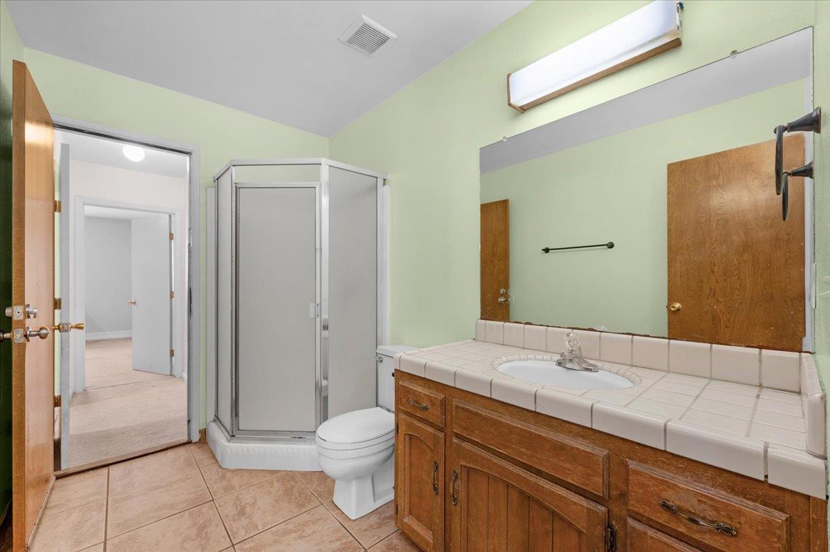 28340 Tollhouse Road Tollhouse, CA 93667 - Photo 19 of 37 a bathroom with a sink a toilet and shower