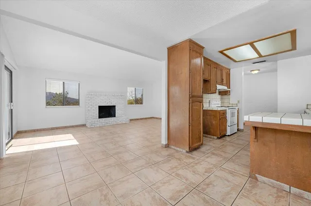a view of a kitchen with a sink and a refrigerator
