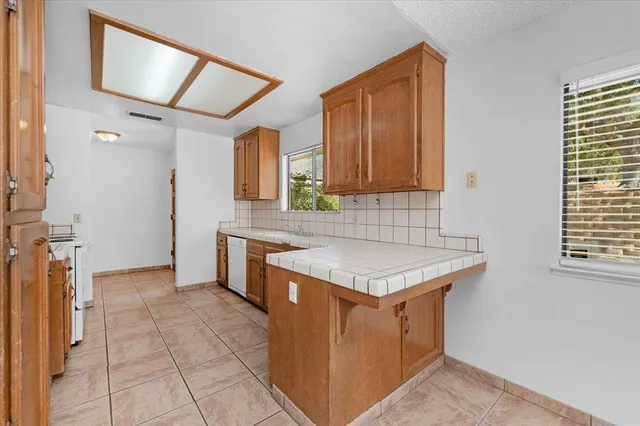 a kitchen with a stove a sink and a refrigerator