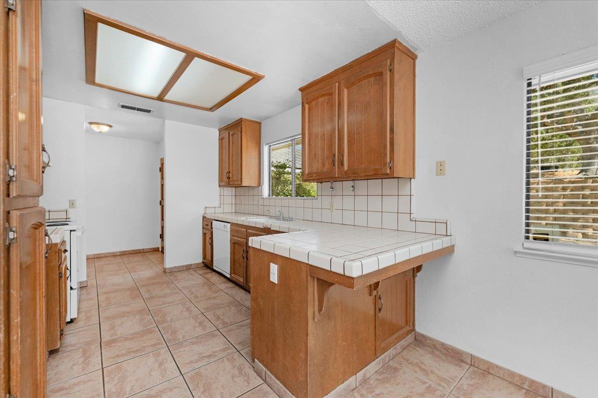 28340 Tollhouse Road Tollhouse, CA 93667 - Photo 7 of 37 a kitchen with a stove a sink and a refrigerator